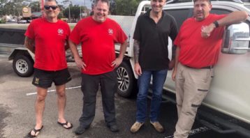 Animal Evac volunteers standing in a car park by a four wheel drive